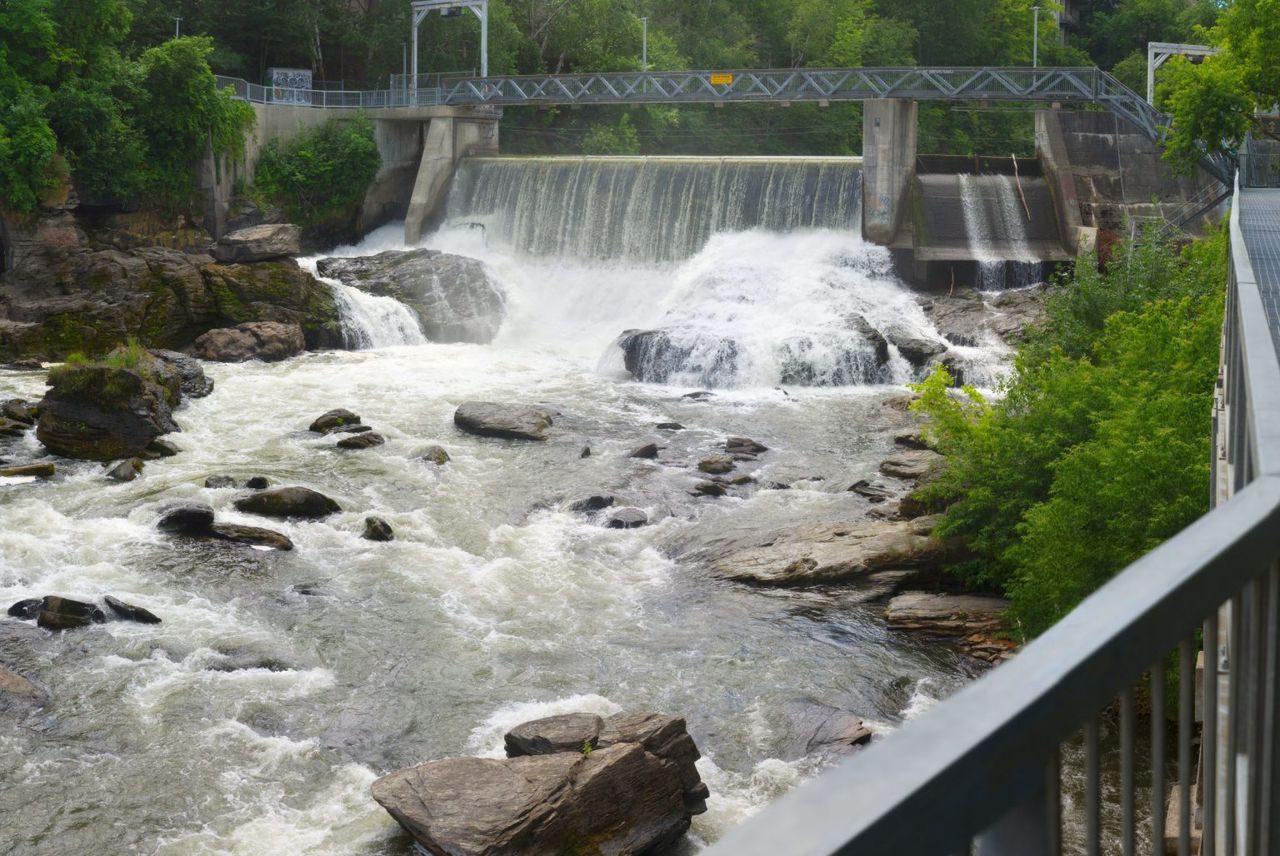 An intake weir on a river, with the footbridge above it